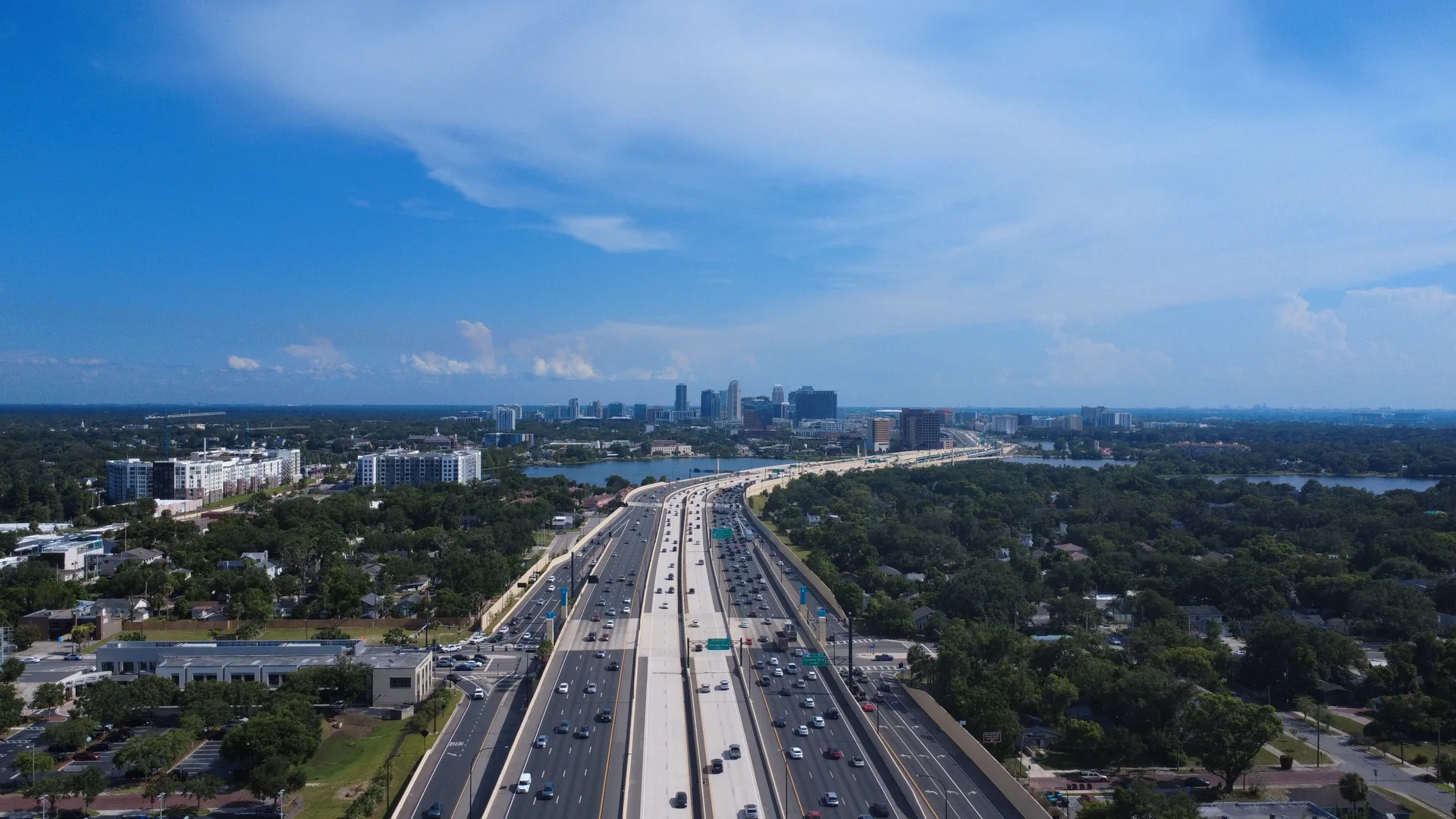 Aerial view of a highway leading toward the Orlando skyline